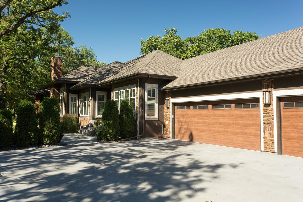 Photo of a large and brown contemporary bungalow detached house in Other with stone cladding, a hip roof and a shingle roof.