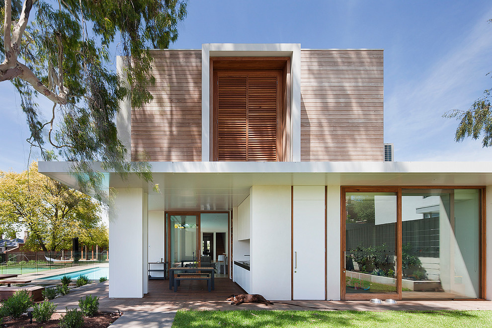 Photo of a white modern two floor house exterior in Melbourne with wood cladding and a flat roof.