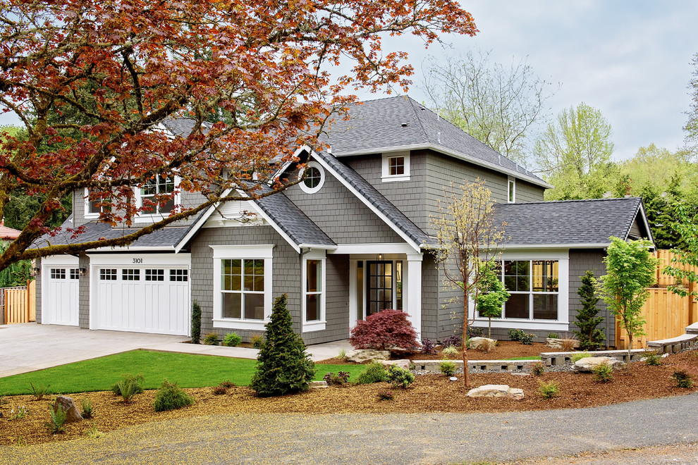 Inspiration for a mid-sized transitional gray two-story exterior home remodel in Portland with a hip roof