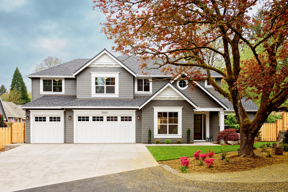 Example of a mid-sized transitional gray two-story exterior home design in Portland with a hip roof