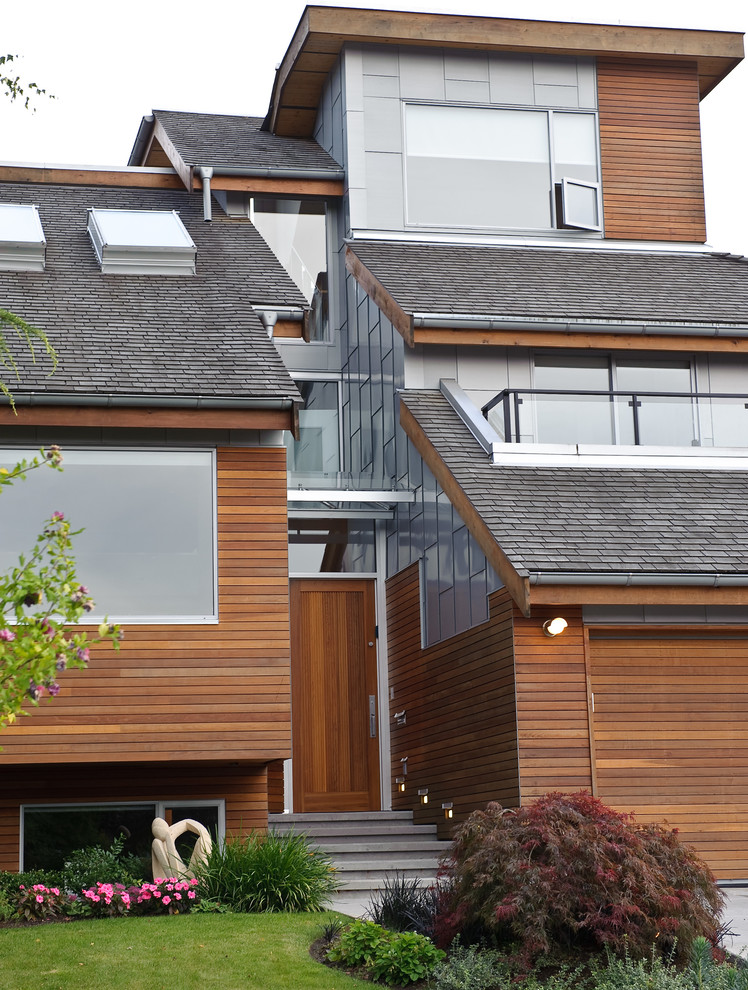 Idee per la facciata di una casa contemporanea a tre piani con rivestimento in legno