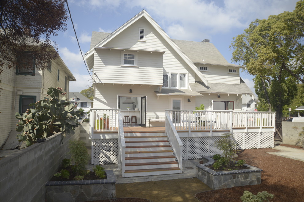 Example of a large arts and crafts white three-story wood exterior home design in Los Angeles