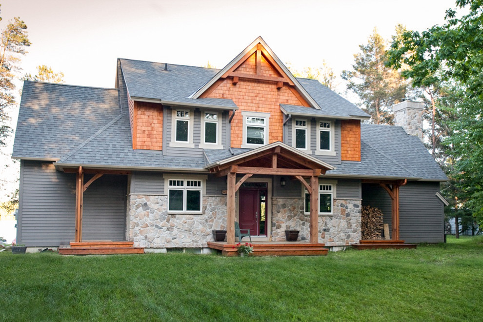 Inspiration for a mid-sized rustic gray two-story mixed siding exterior home remodel in Ottawa with a shingle roof