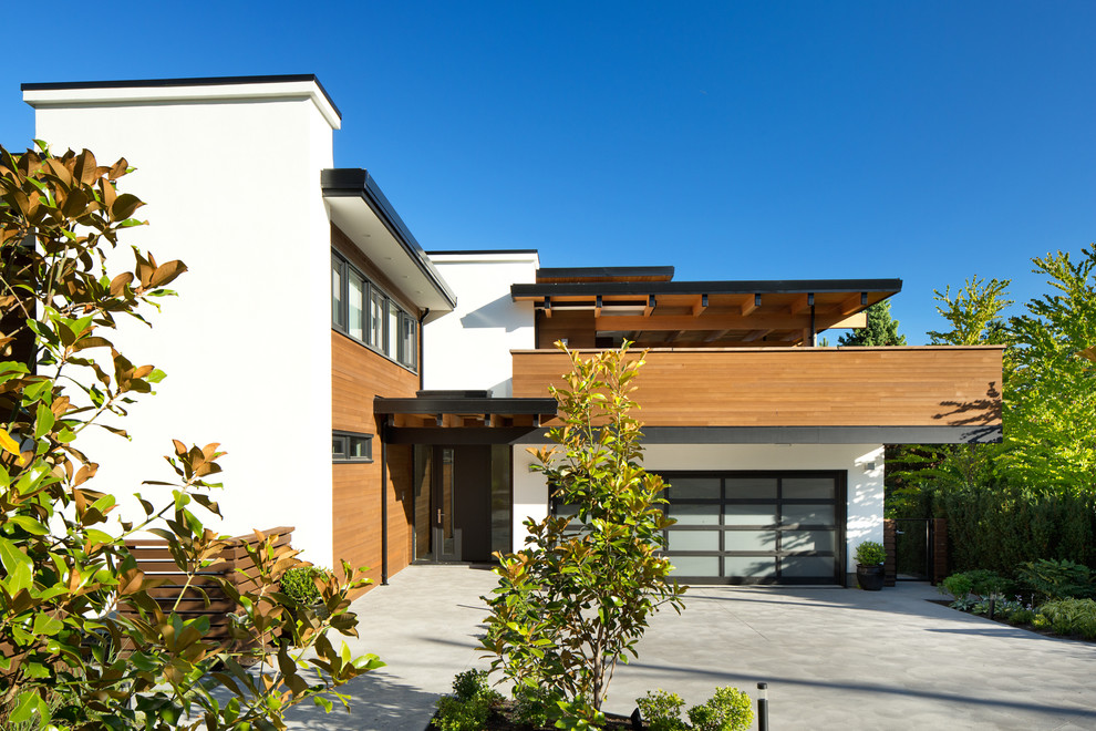 Inspiration for a mid-sized contemporary white two-story mixed siding exterior home remodel in Vancouver