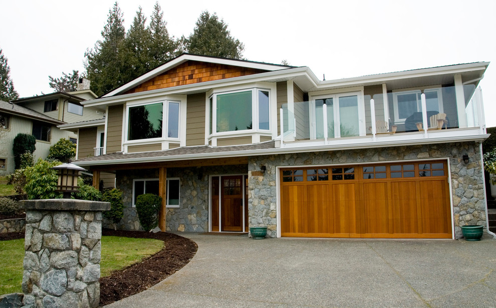 Example of a large classic gray two-story concrete fiberboard gable roof design in Vancouver