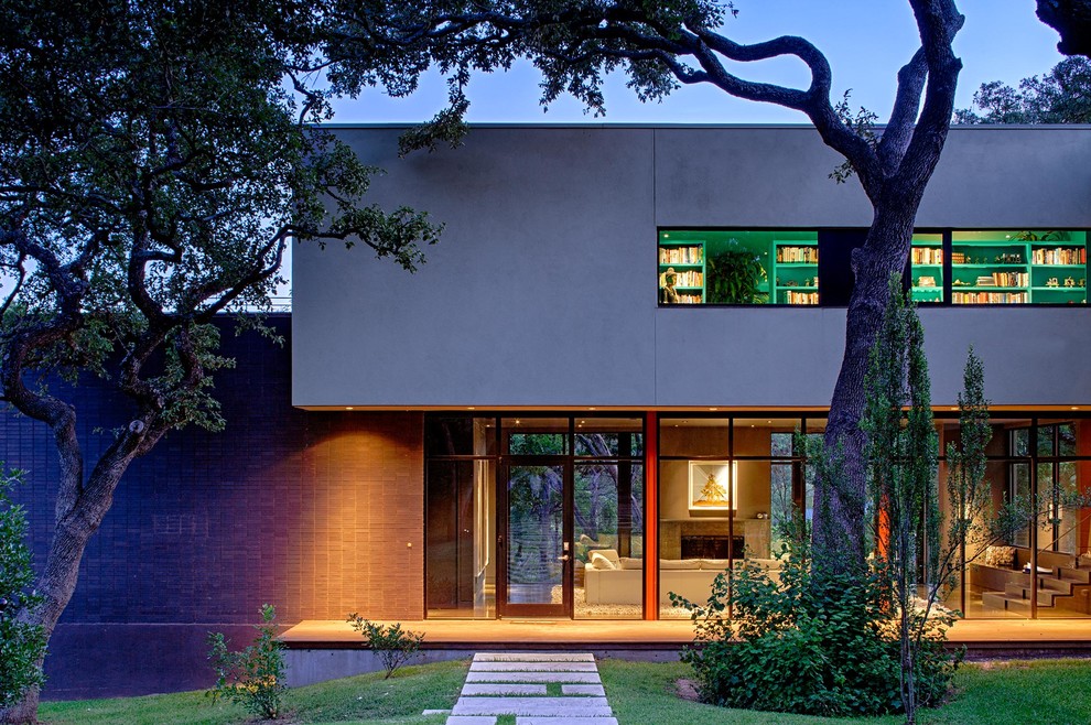 Example of a trendy gray two-story exterior home design in Austin