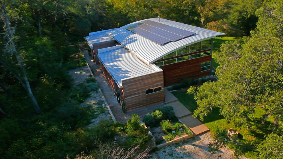 Example of a minimalist wood exterior home design in Austin