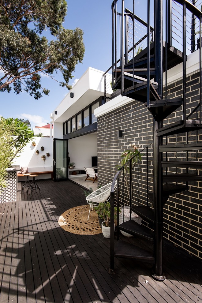 Small trendy gray one-story brick flat roof photo in Perth