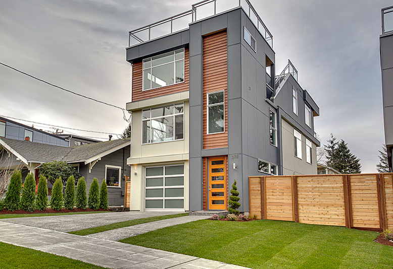 Example of a large minimalist gray three-story concrete fiberboard exterior home design in Seattle