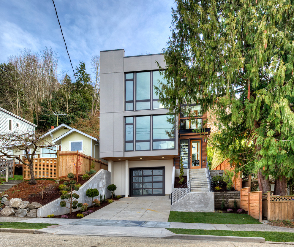 Photo of a medium sized and beige modern house exterior in Seattle with three floors, concrete fibreboard cladding and a flat roof.