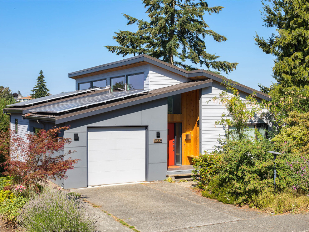 Mittelgroßes, Zweistöckiges Modernes Einfamilienhaus mit Mix-Fassade, bunter Fassadenfarbe, Pultdach und Blechdach in Seattle