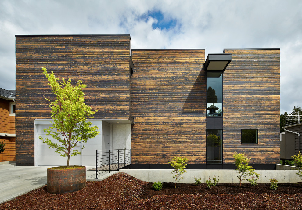 Diseño de fachada actual de dos plantas con revestimiento de madera y tejado plano