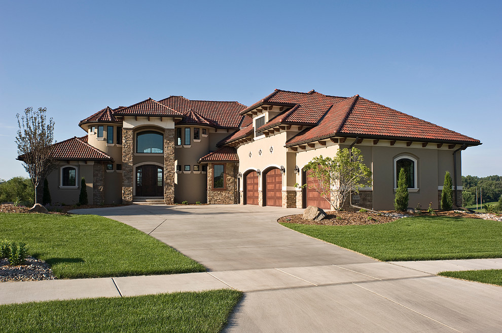 Large and beige mediterranean two floor render house exterior in Other with a hip roof.