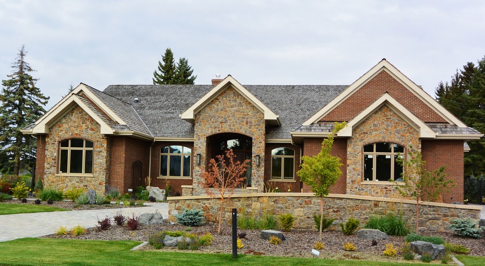 Inspiration for a brown contemporary bungalow brick house exterior in Edmonton.