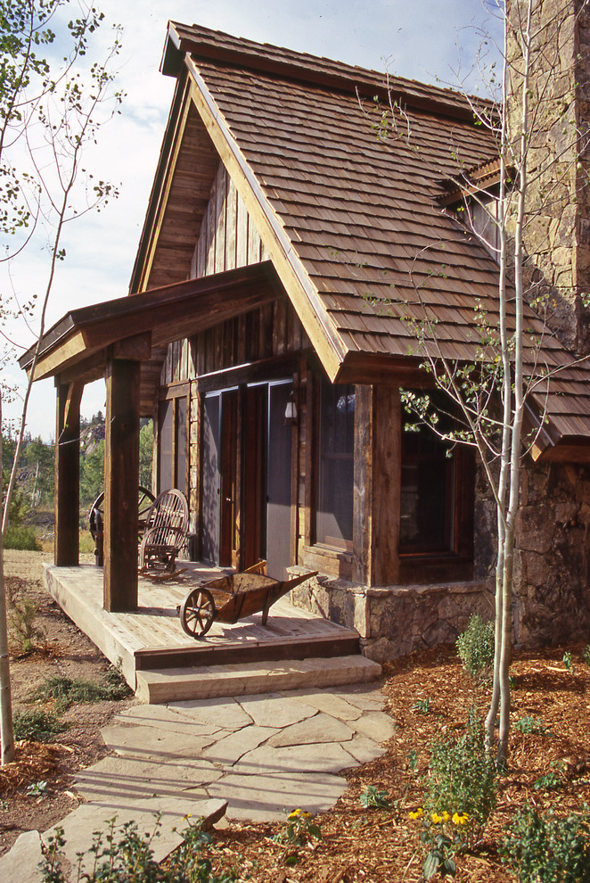 Rustic wood exterior home idea in Denver