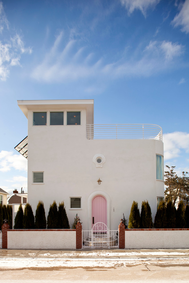 White mediterranean two floor house exterior in New York with a flat roof.