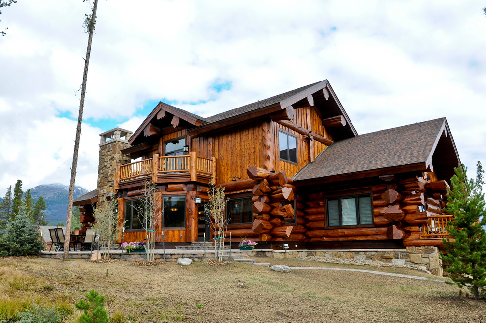 Large rustic brown split-level mixed siding exterior home idea in Denver with a shingle roof