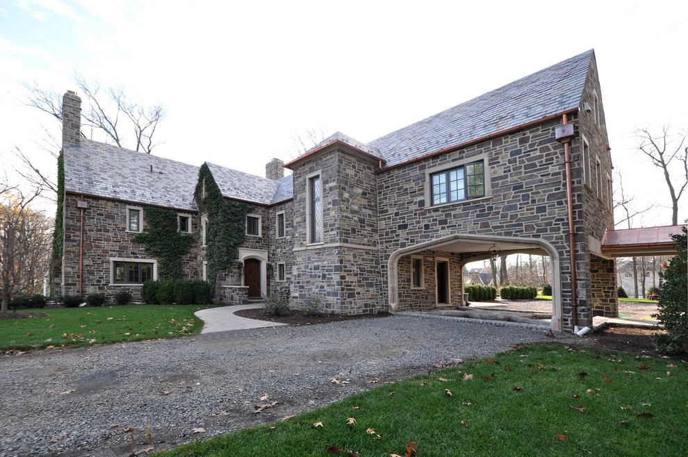 Large traditional multicolored two-story stone gable roof idea in Newark