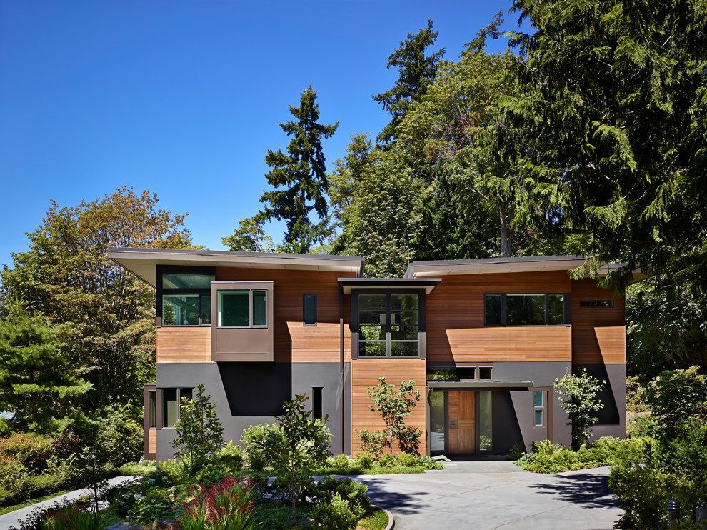 Свежая идея для дизайна: деревянный, большой, трехэтажный, разноцветный частный загородный дом в современном стиле с плоской крышей и зеленой крышей - отличное фото интерьера