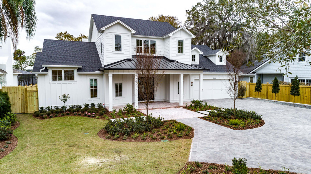 Large cottage white two-story wood exterior home idea in Orlando with a mixed material roof