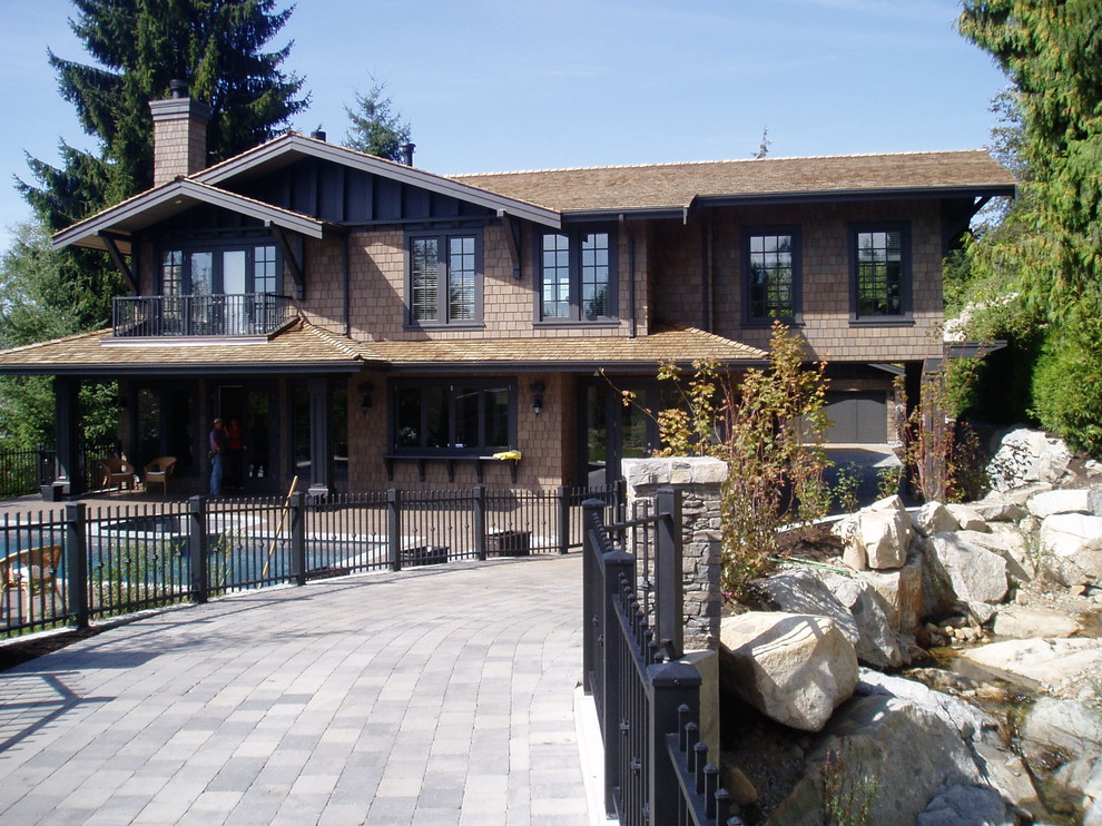 Example of a large classic brown two-story wood exterior home design in Vancouver with a shingle roof