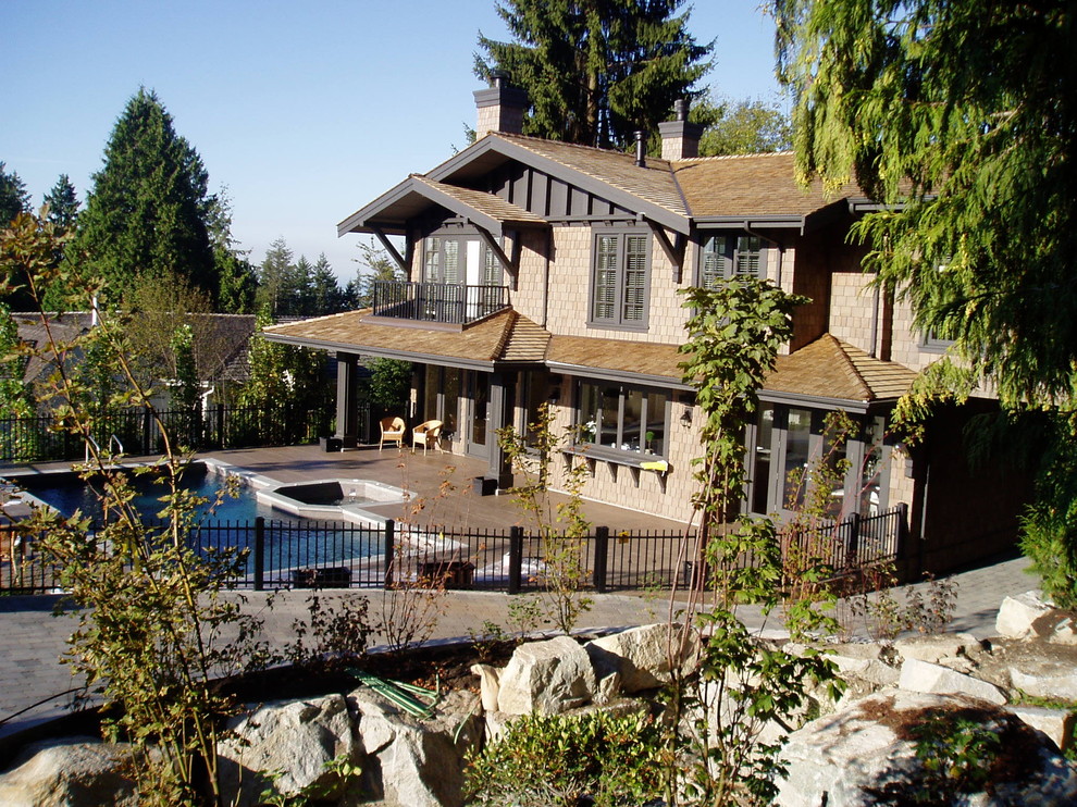 Example of a large classic brown two-story wood exterior home design in Vancouver with a shingle roof