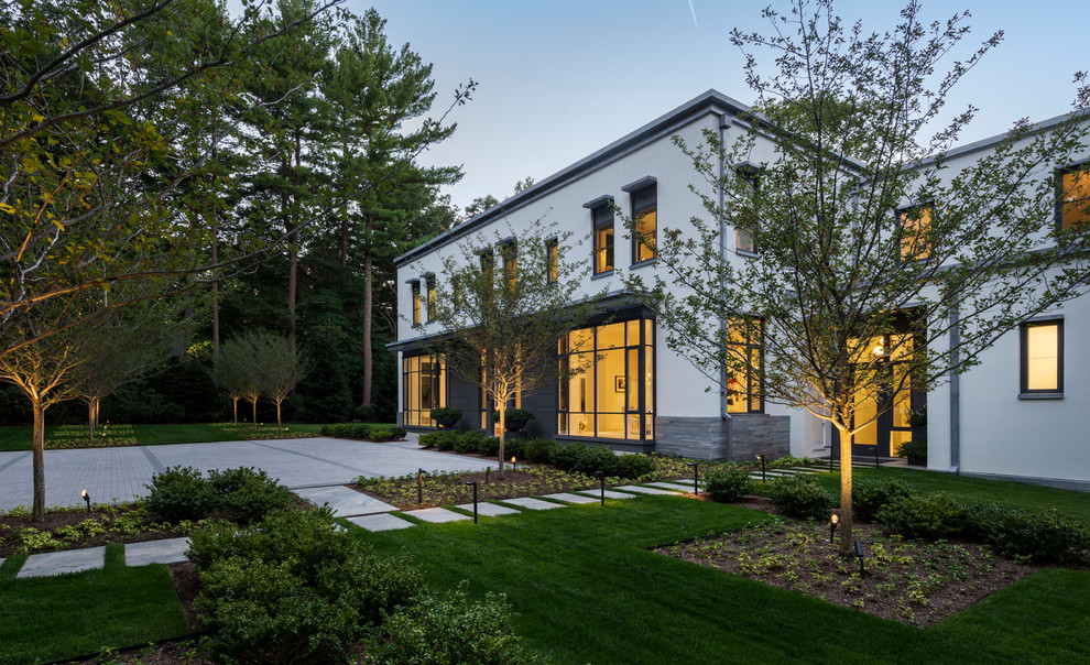 Imagen de fachada blanca minimalista grande de dos plantas con revestimientos combinados