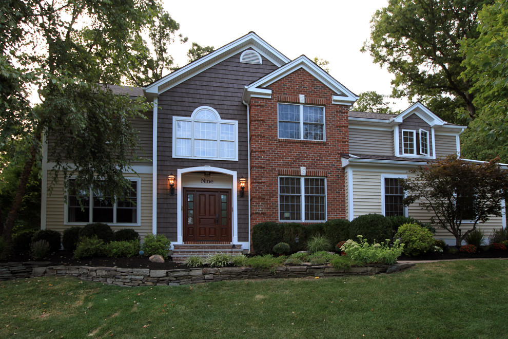 Example of a large classic two-story vinyl exterior home design in Newark