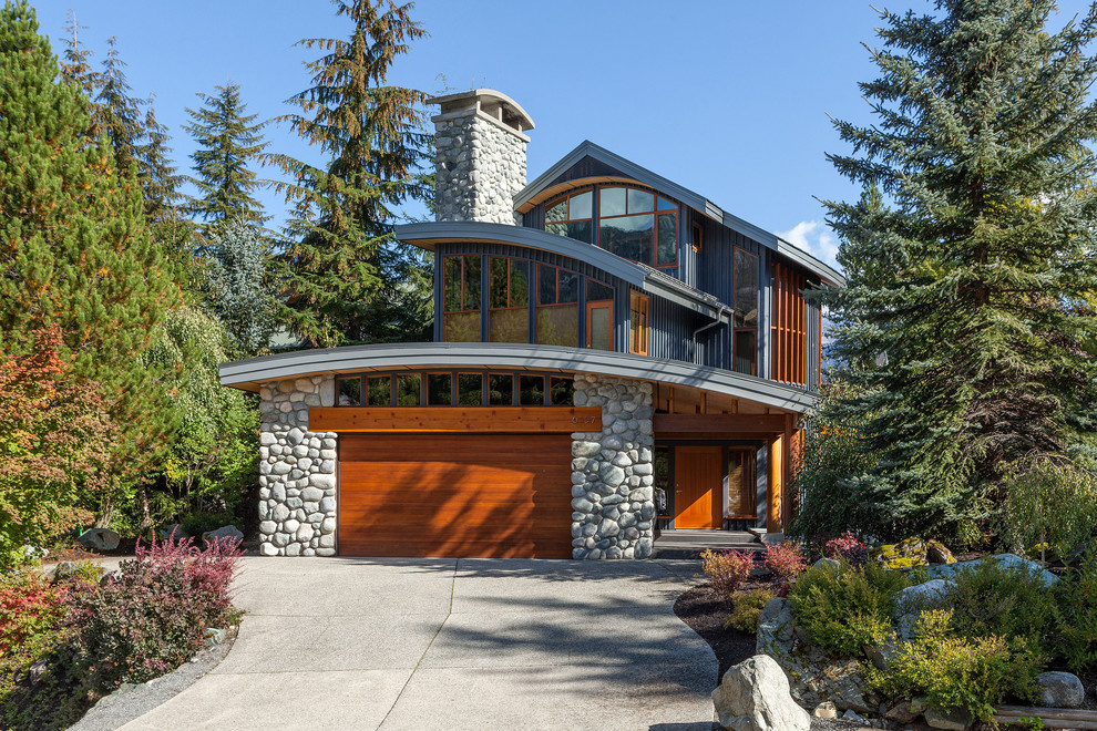 Imagen de fachada de casa gris minimalista grande de tres plantas con revestimientos combinados, tejado a dos aguas y tejado de metal