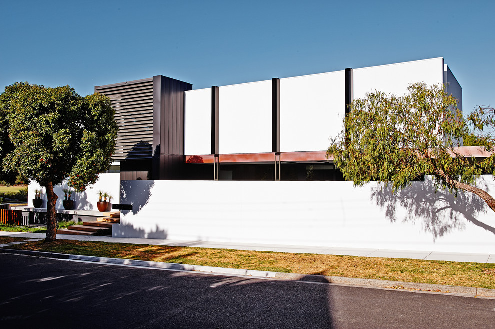 Example of a trendy white exterior home design in Melbourne