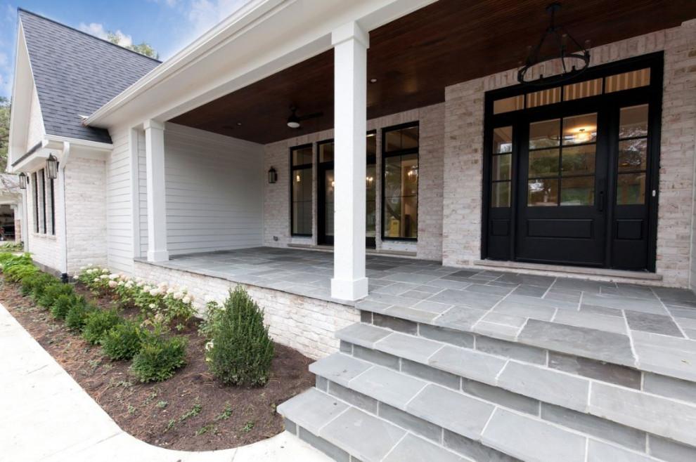 Large cottage white two-story brick exterior home photo in Chicago with a shingle roof