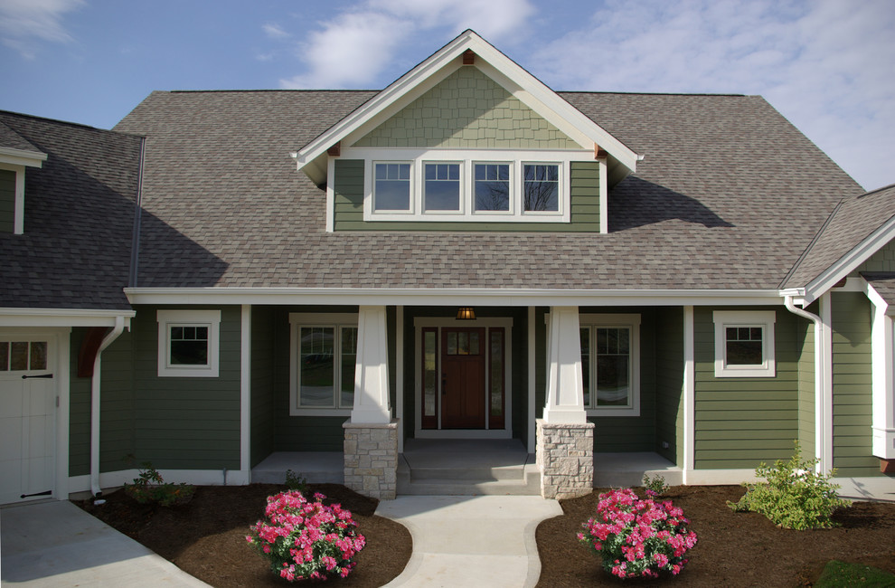 Mid-sized elegant green two-story wood gable roof photo in Milwaukee