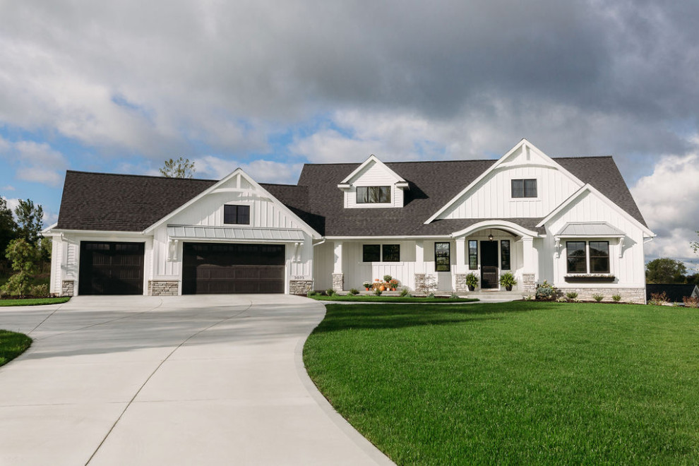 Large country white one-story wood house exterior idea in Grand Rapids with a mixed material roof and a hip roof