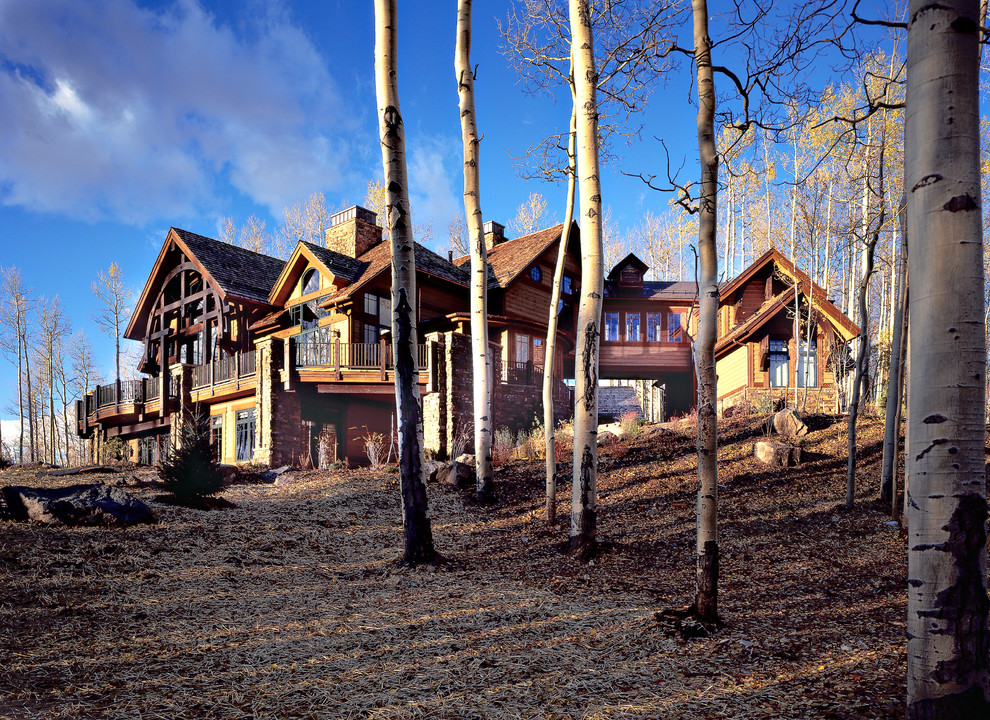 Example of a minimalist brown three-story wood gable roof design in Denver