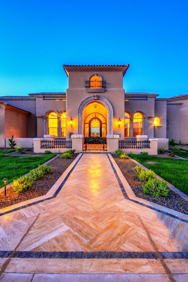 Inspiration for a medium sized and beige mediterranean bungalow render house exterior in Phoenix.