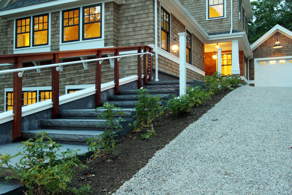 На фото: большой, двухэтажный, деревянный, коричневый дом в стиле кантри с полувальмовой крышей с