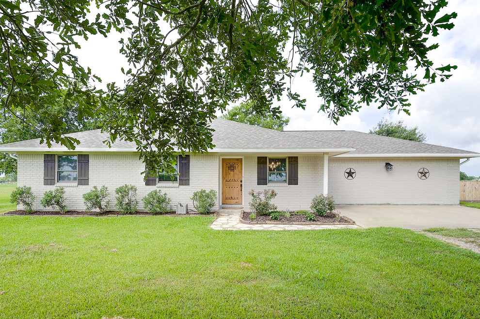 Inspiration for a small and white classic bungalow brick detached house in Houston with a hip roof and a shingle roof.