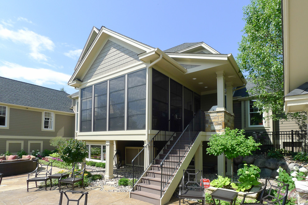 Example of a classic brown two-story concrete fiberboard gable roof design in Minneapolis