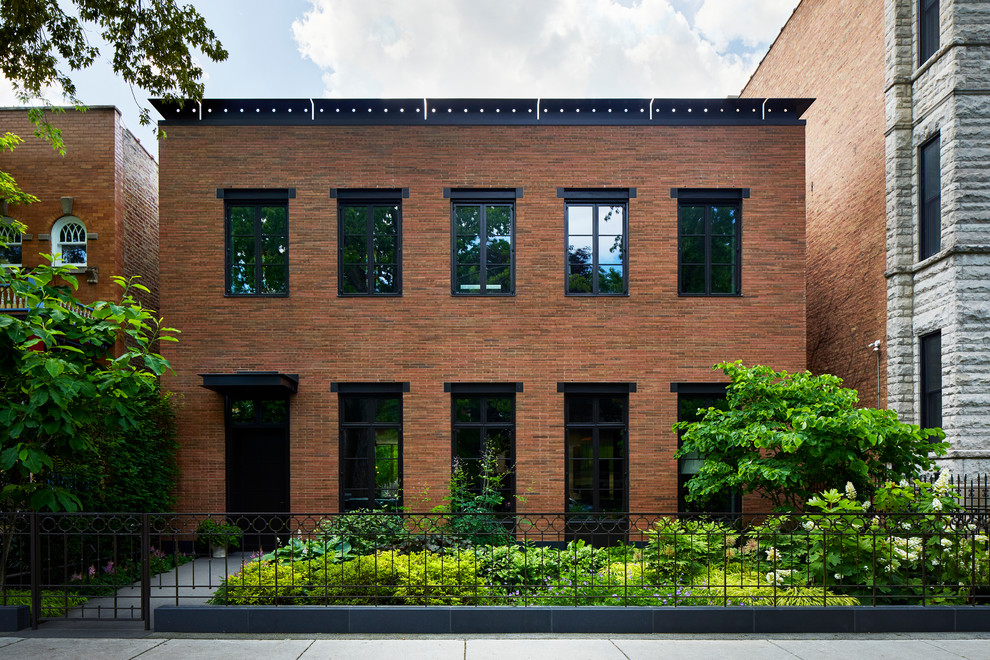Large contemporary two-story brick exterior home idea in Chicago
