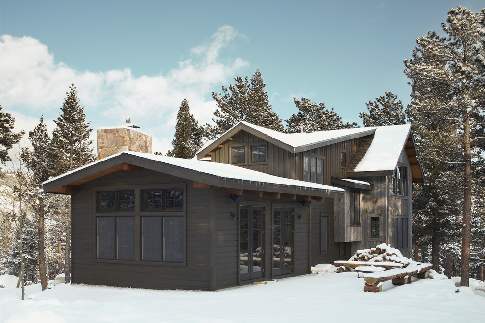 Example of a mountain style black two-story wood exterior home design in Denver