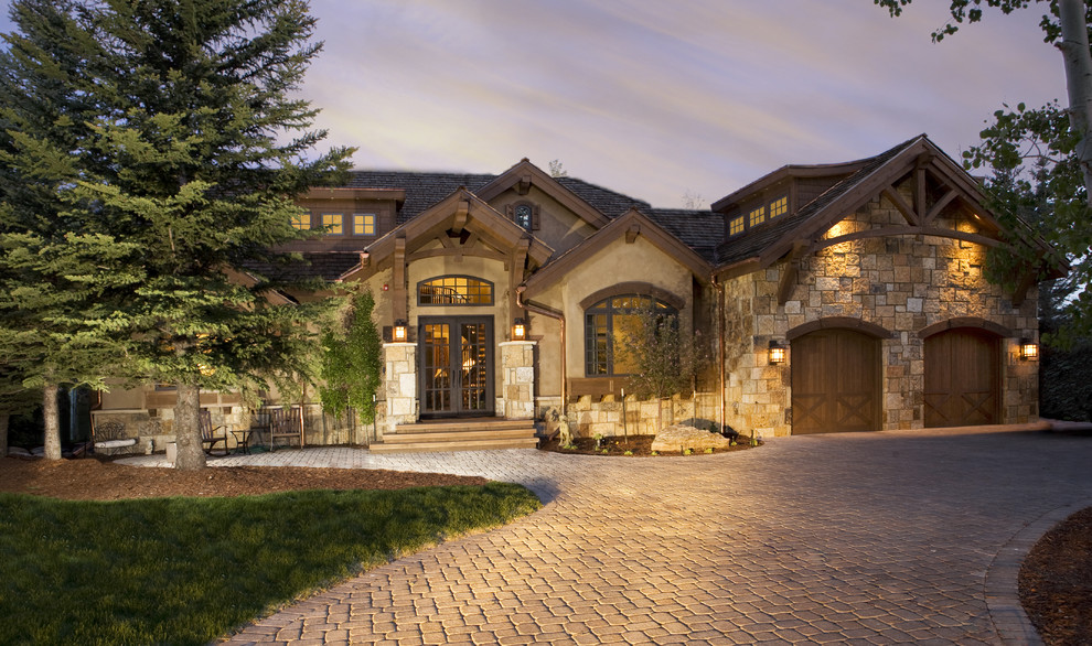 Example of a mountain style two-story stone exterior home design in Denver