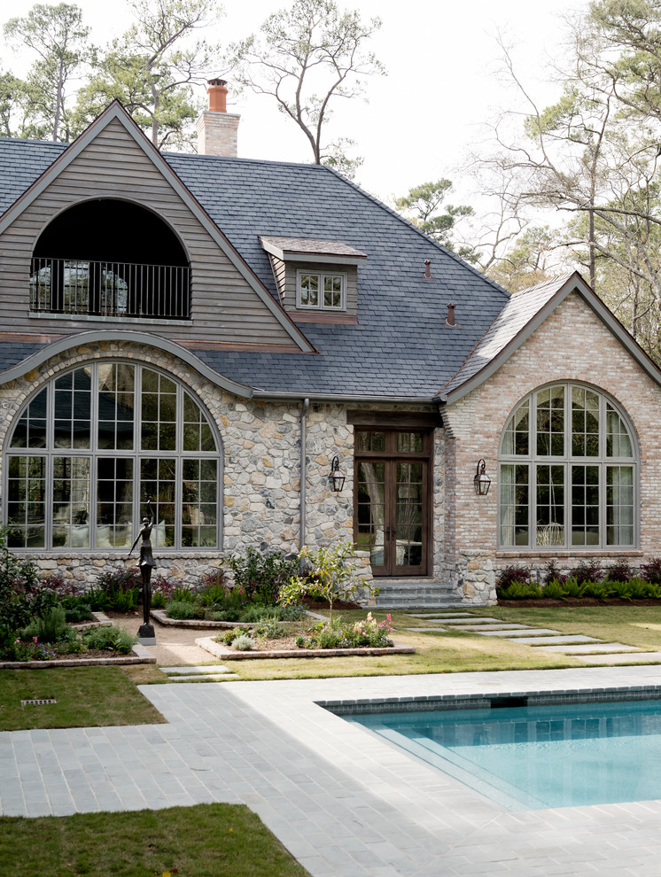 Inspiration for a traditional house exterior in Houston with stone cladding.