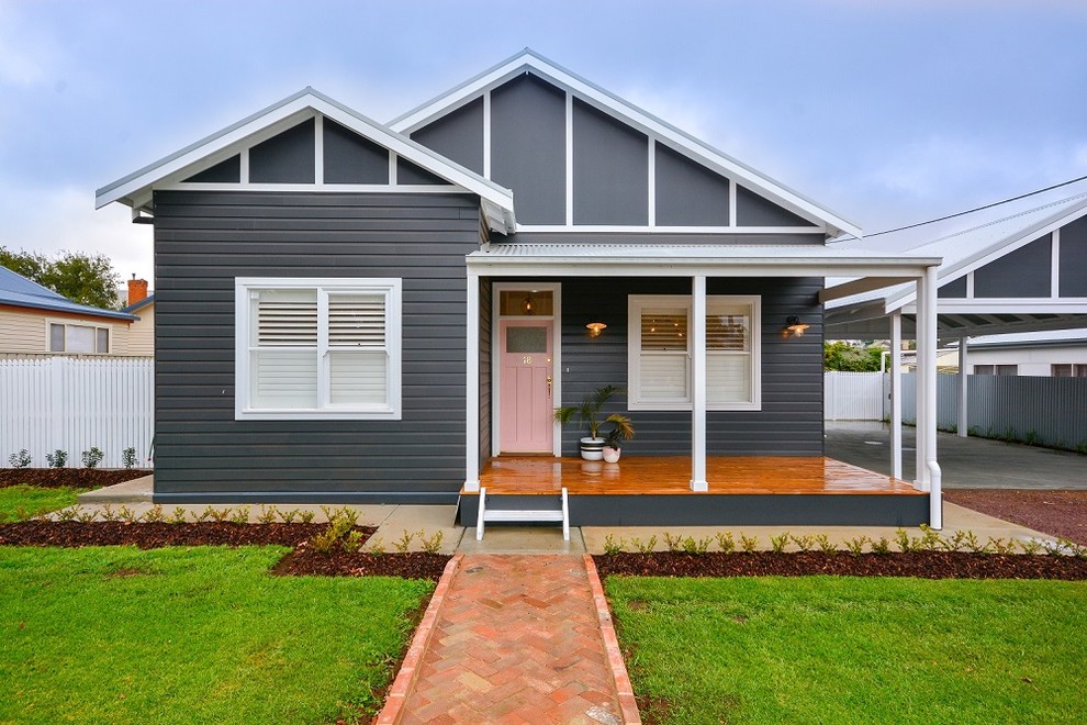 Photo of a medium sized and gey classic bungalow detached house in Brisbane with wood cladding.