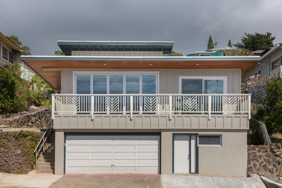 Inspiration for a large transitional gray split-level wood flat roof remodel in Hawaii