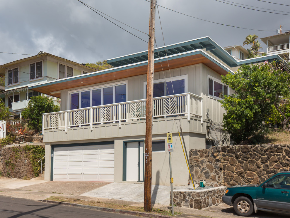 Large transitional gray split-level wood flat roof idea in Hawaii