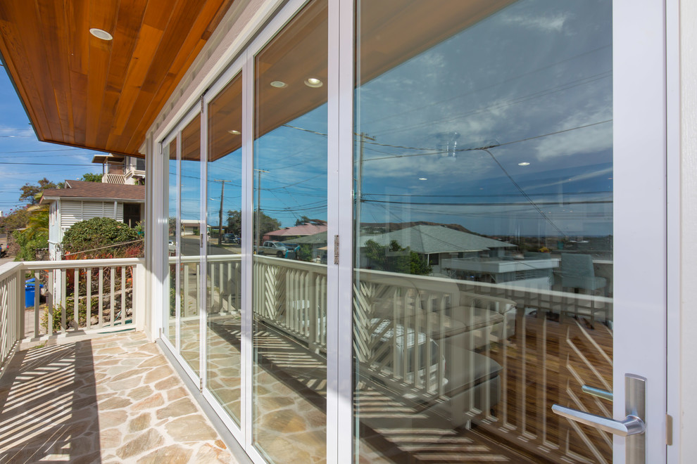 Large transitional gray split-level wood flat roof photo in Hawaii