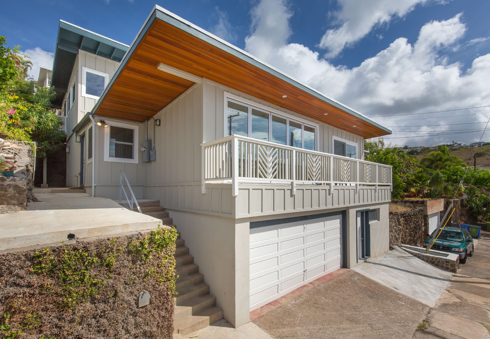 Large transitional gray split-level wood flat roof photo in Hawaii
