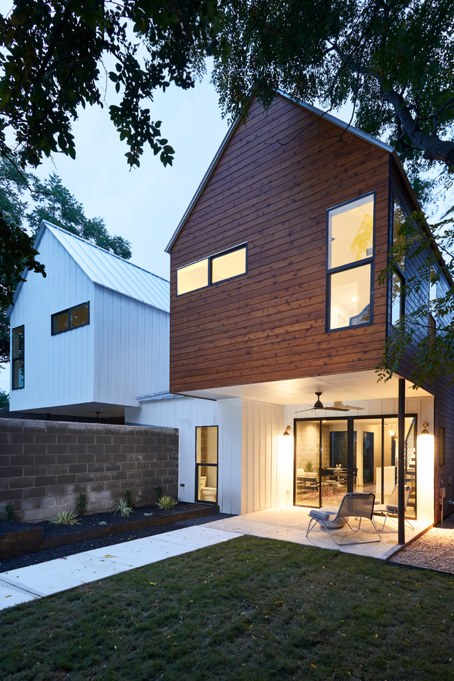 Example of a small trendy two-story wood exterior home design in Austin with a metal roof