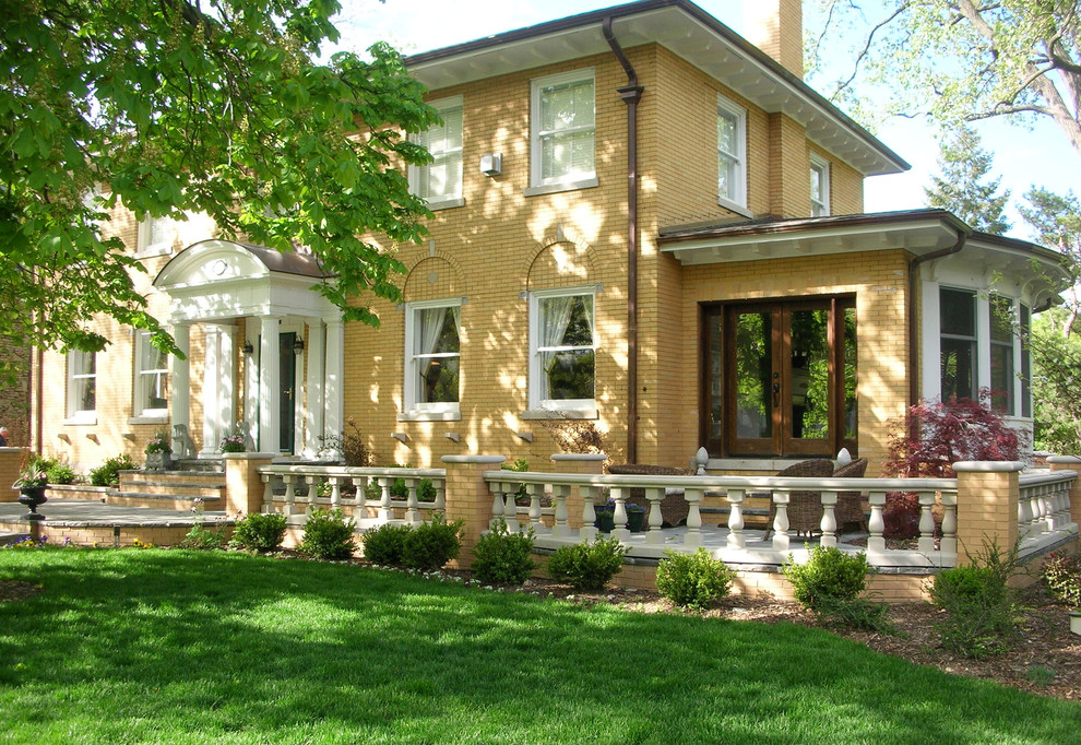 Inspiration for a mid-sized timeless two-story brick exterior home remodel in Chicago