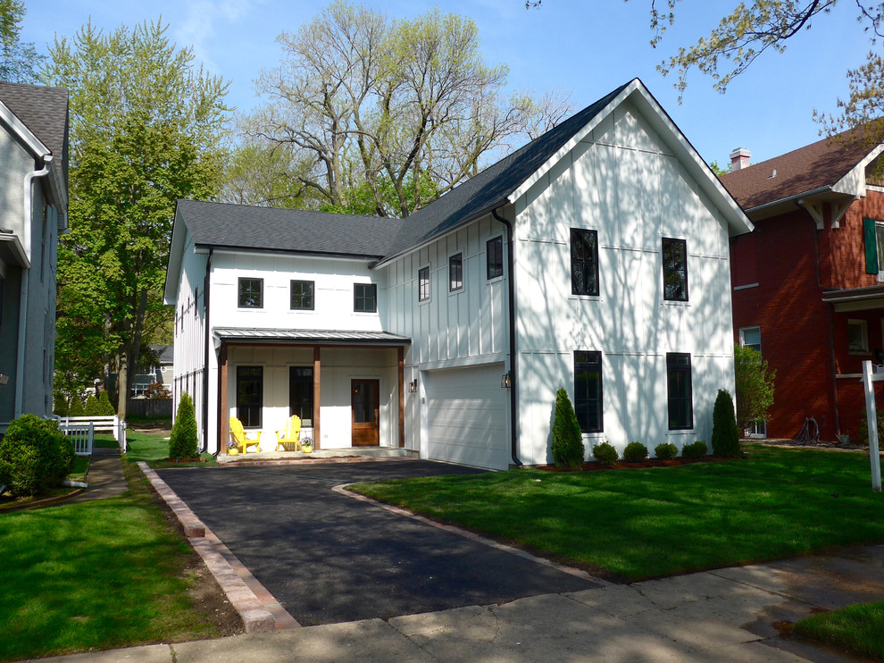 Example of a mid-sized minimalist white two-story concrete fiberboard house exterior design in Chicago with a shingle roof